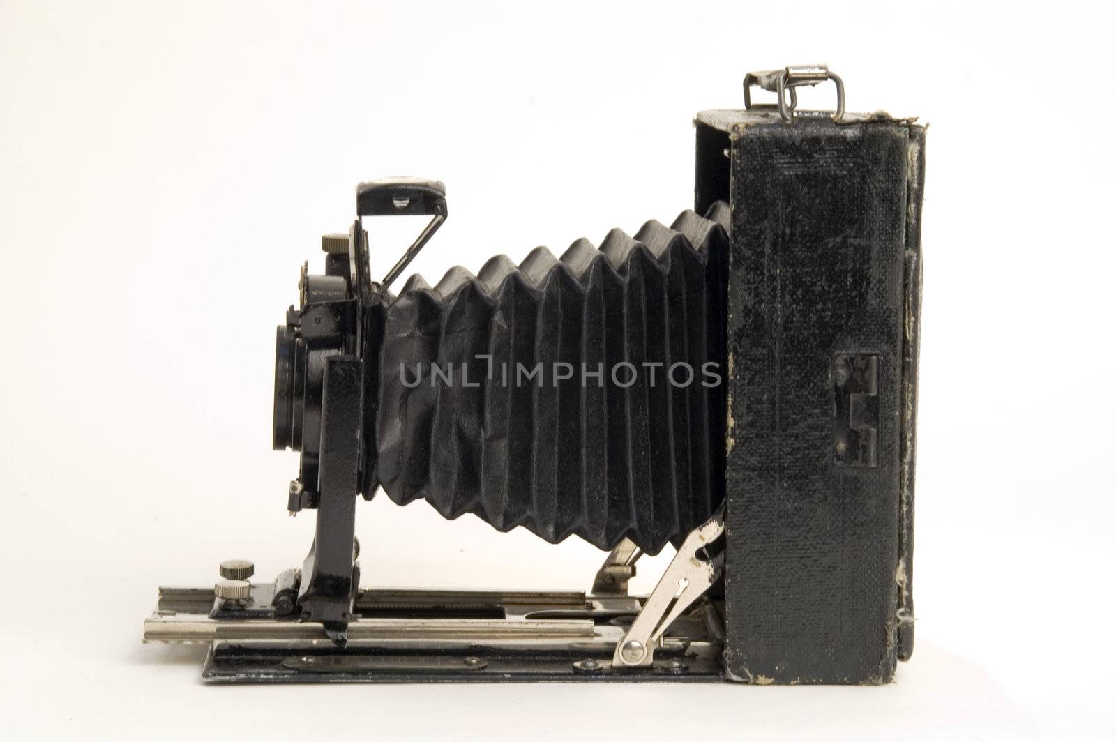 The old photographic chamber with a lens of furs on a white background.