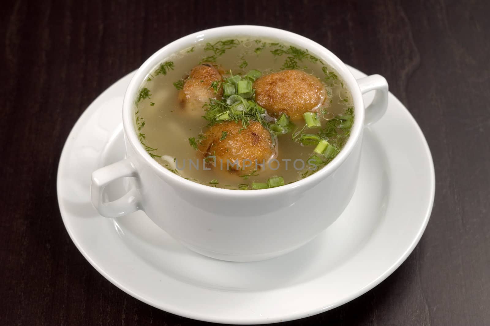 Vegetable soup on a white plate.