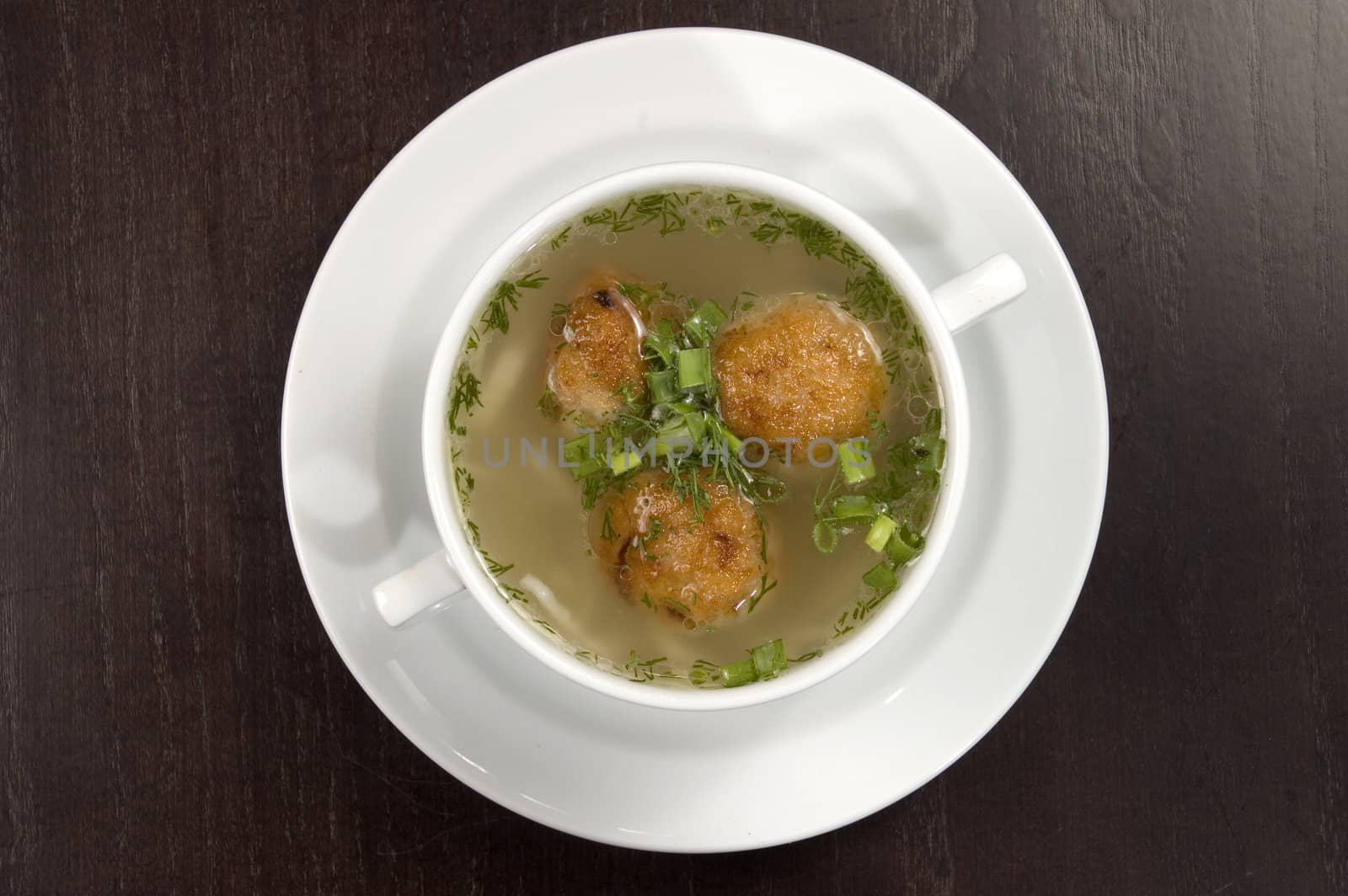 Vegetable soup on a white plate.