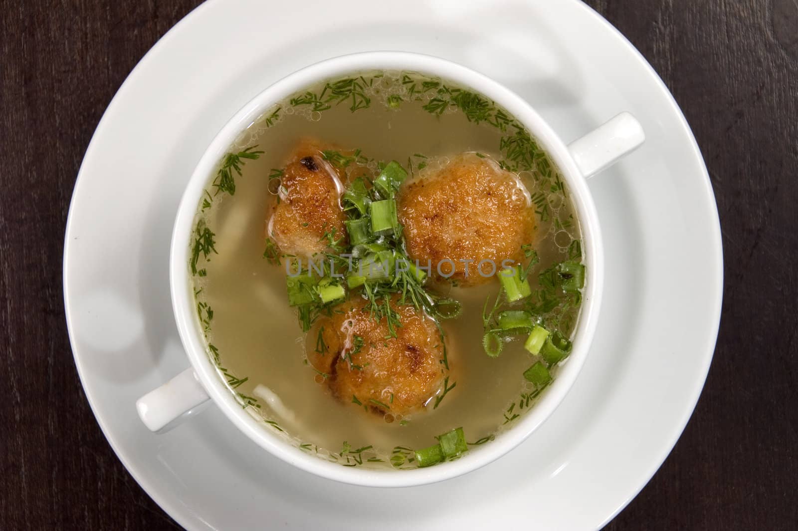 Vegetable soup on a white plate.