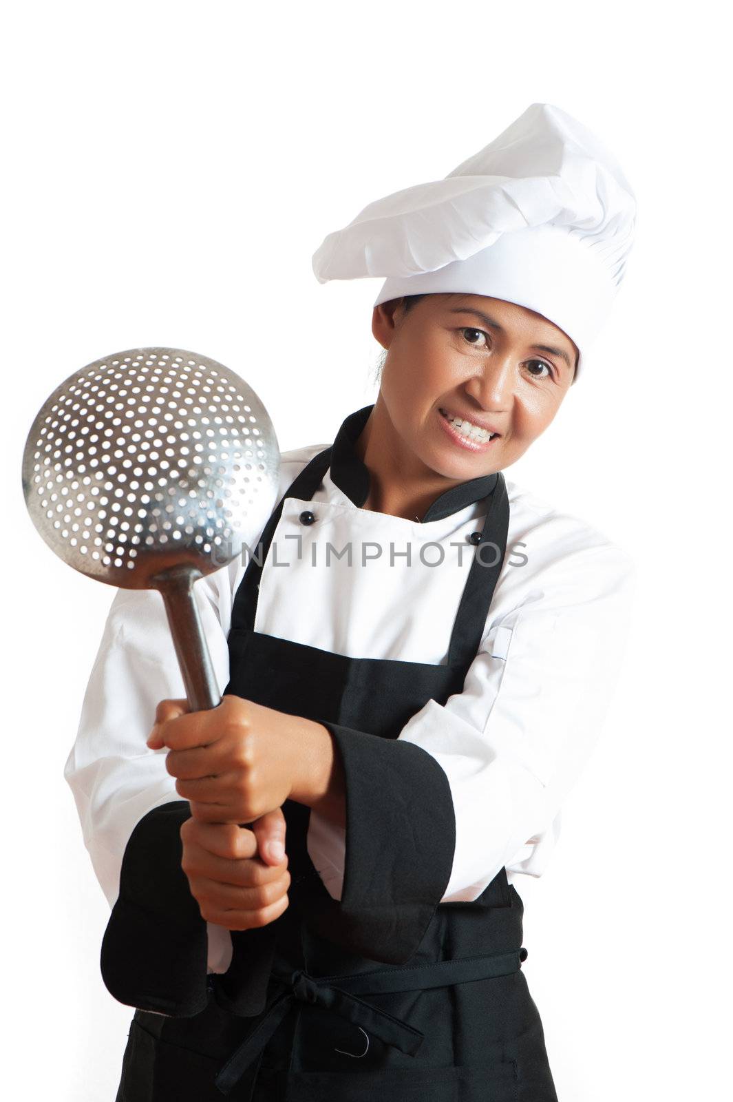 Smiling asian woman as restaurant chef with a kitchen sieve in the hand