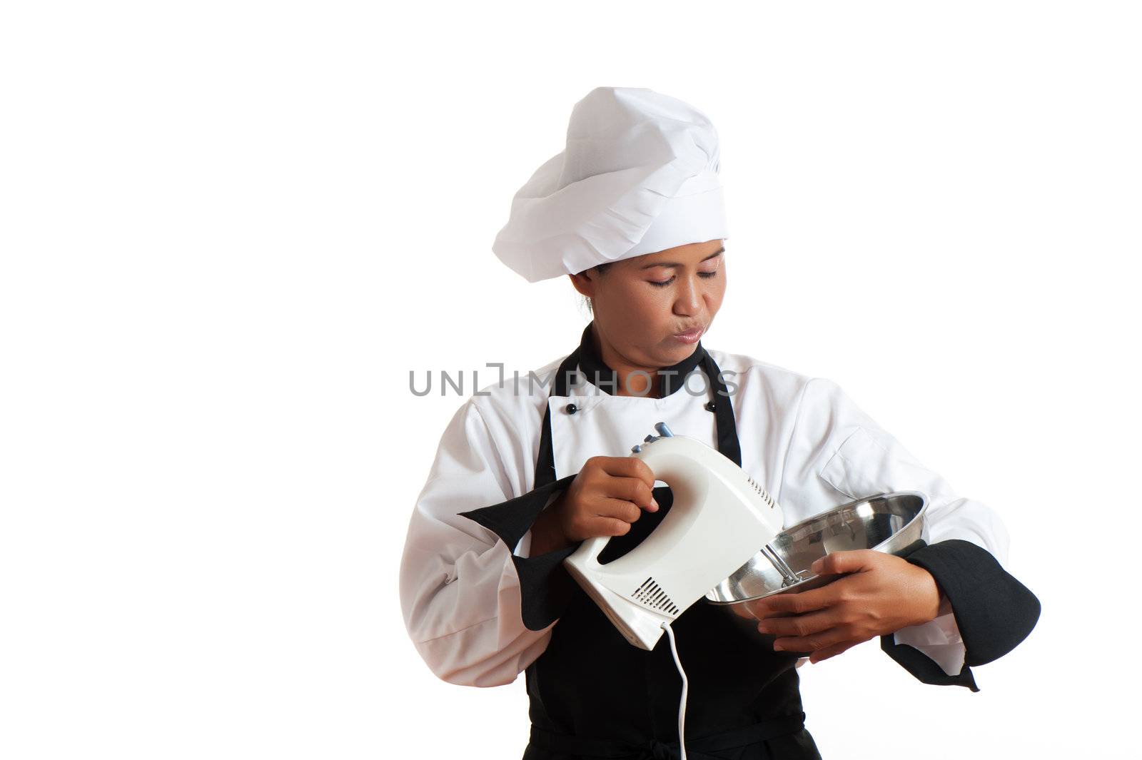 A asian woman as restaurant chef mixing something with a mixer in a bowl