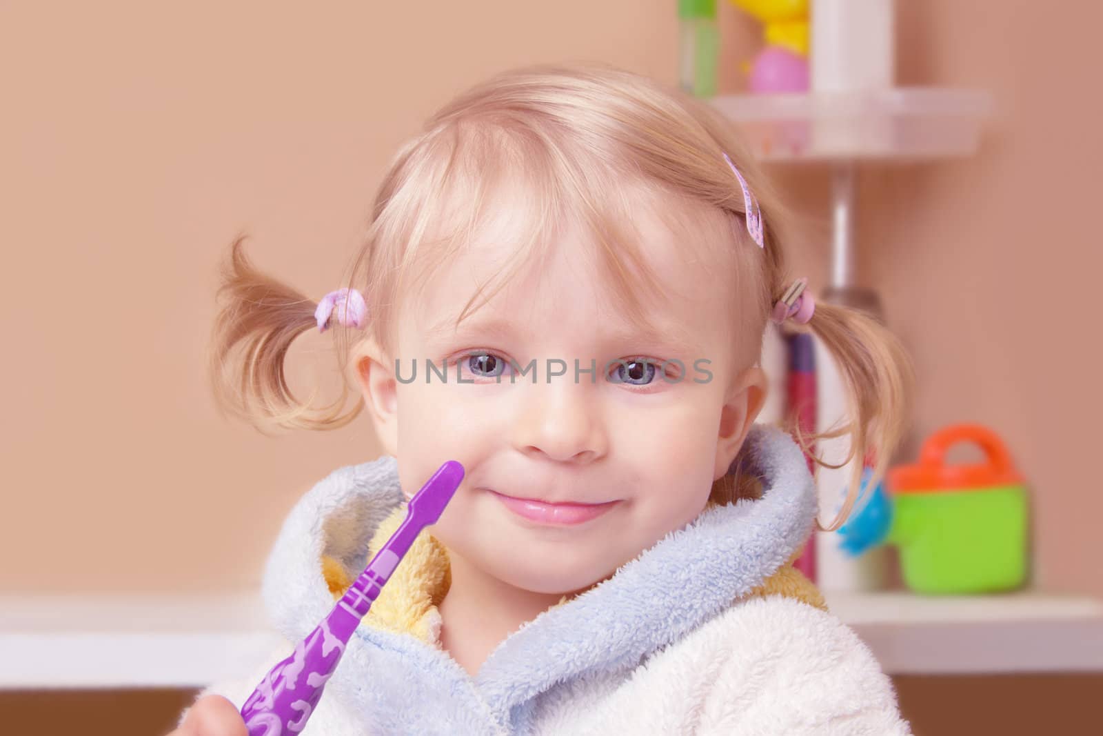 Little girl with toothbrush in bath