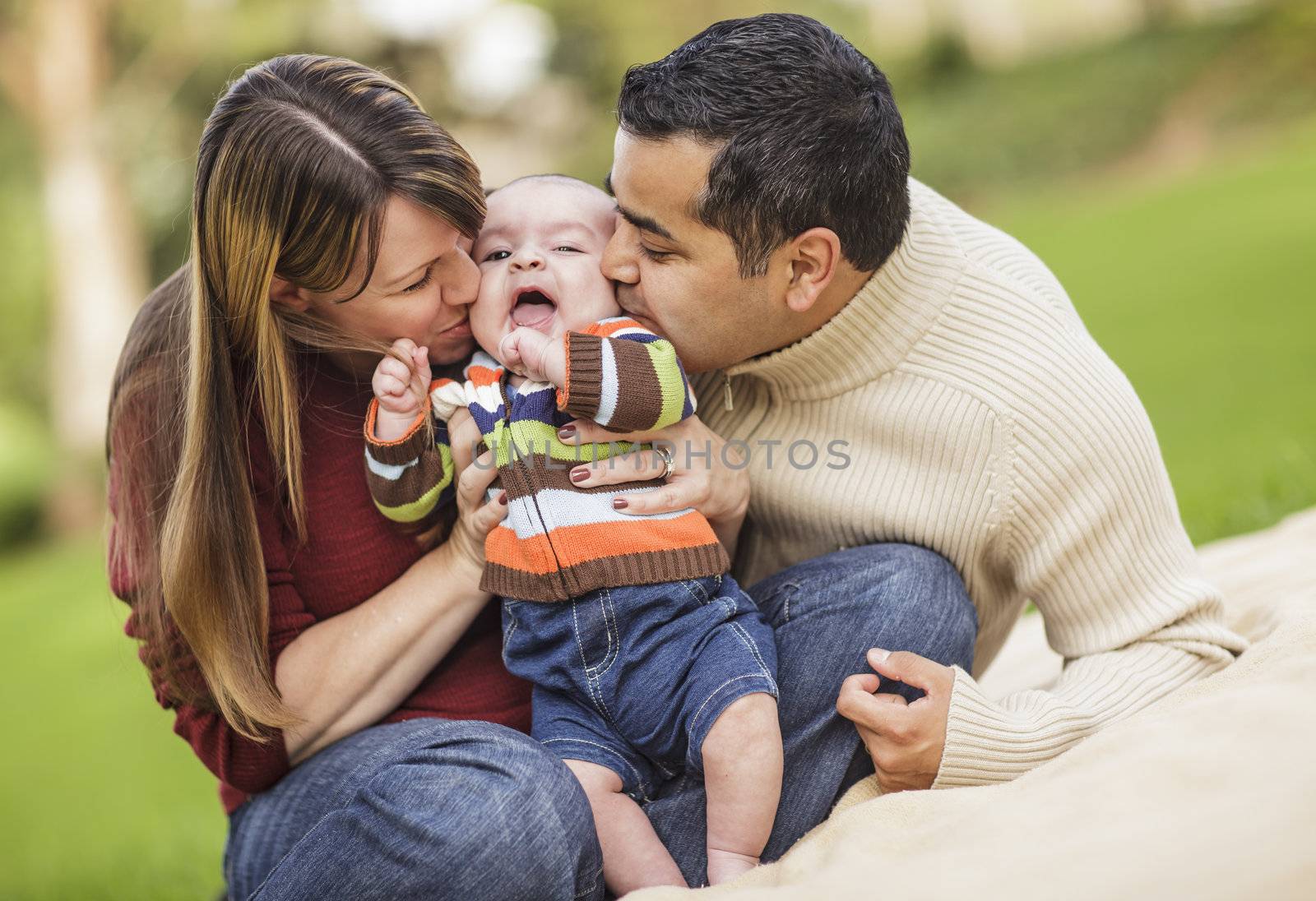 Happy Mixed Race Parents Playing with Their Giggling Son.