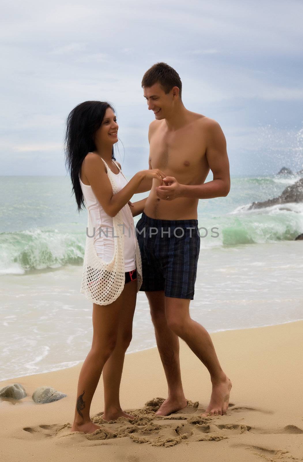 Honeymoon in Thailand. Man and woman on the beach of Patong
