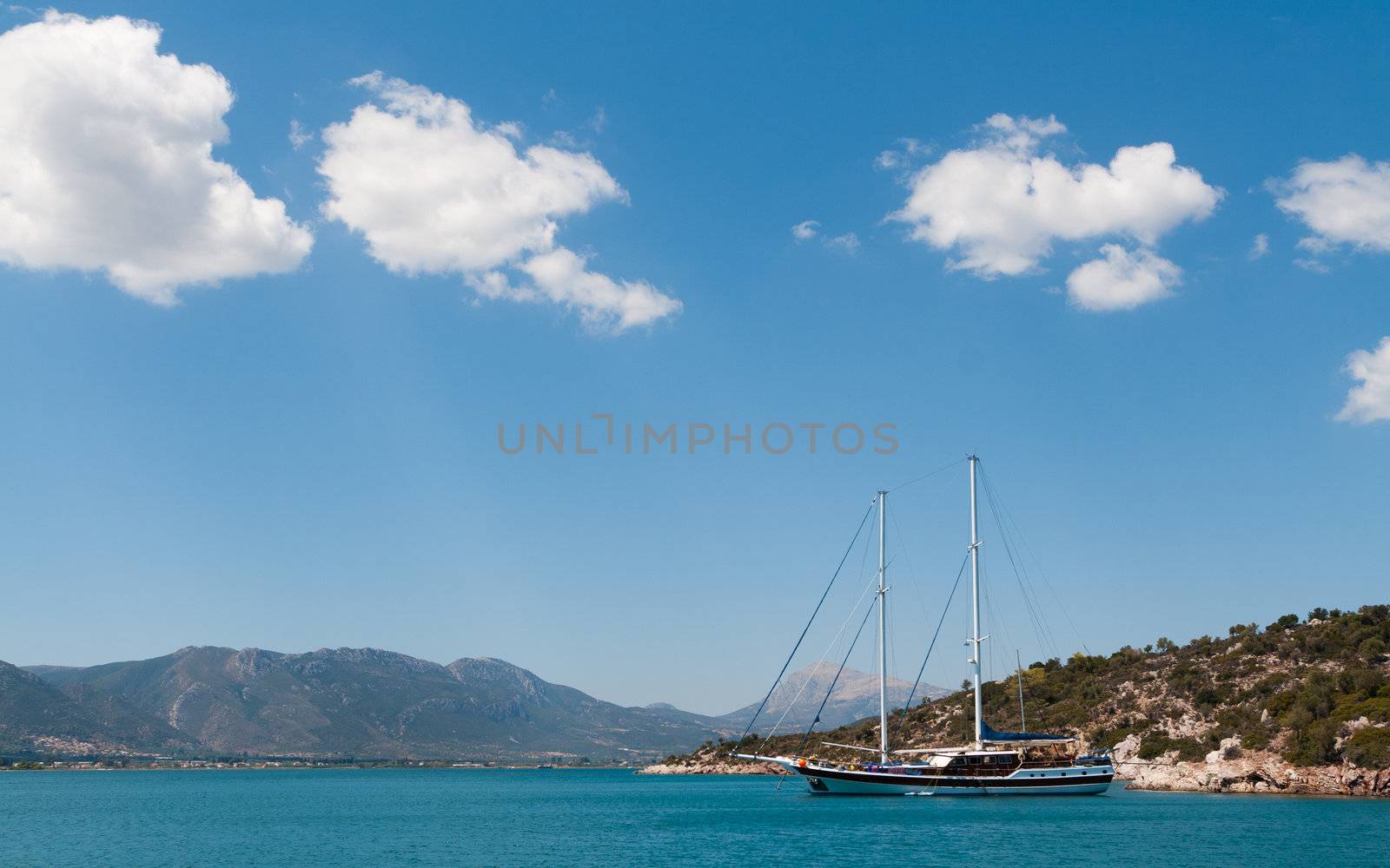 Yacht sailing at Aegean sea near the island of Poros, Greece