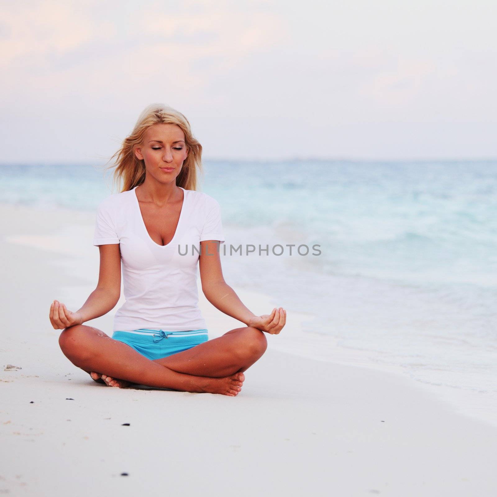 yoga woman on sea coast