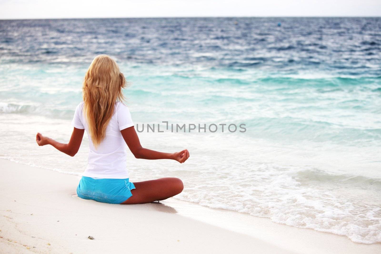 yoga woman on sea coast