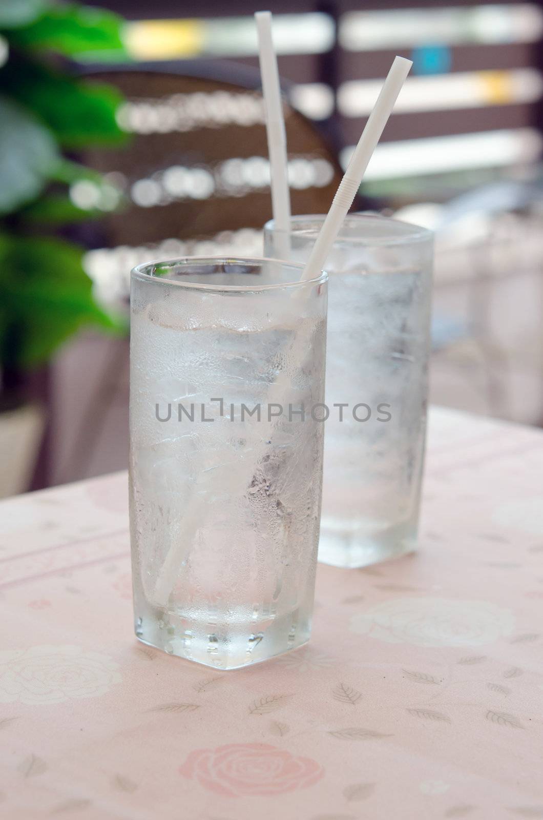 two glass of water with ice on table in restaurant