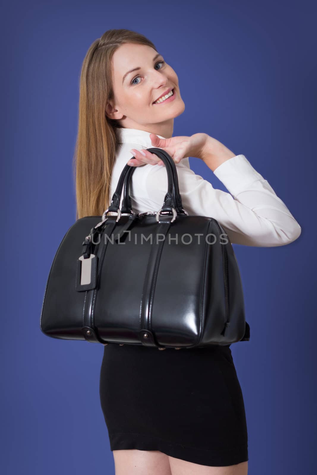 Brunette caucasian woman with a large black handbag