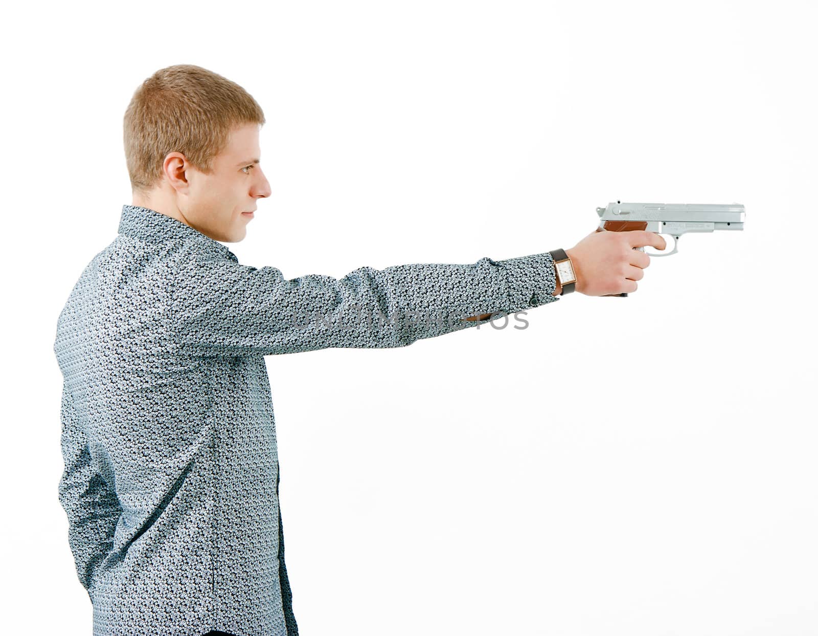 a man with a gun aiming at the distance. profile