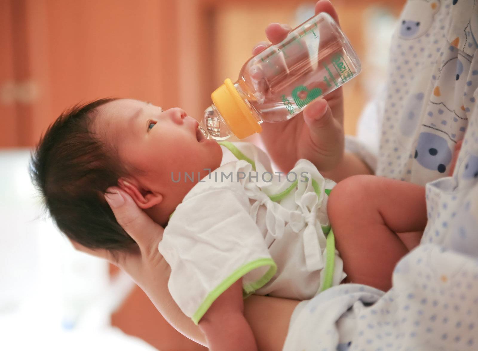 Mother feeding the baby warm.