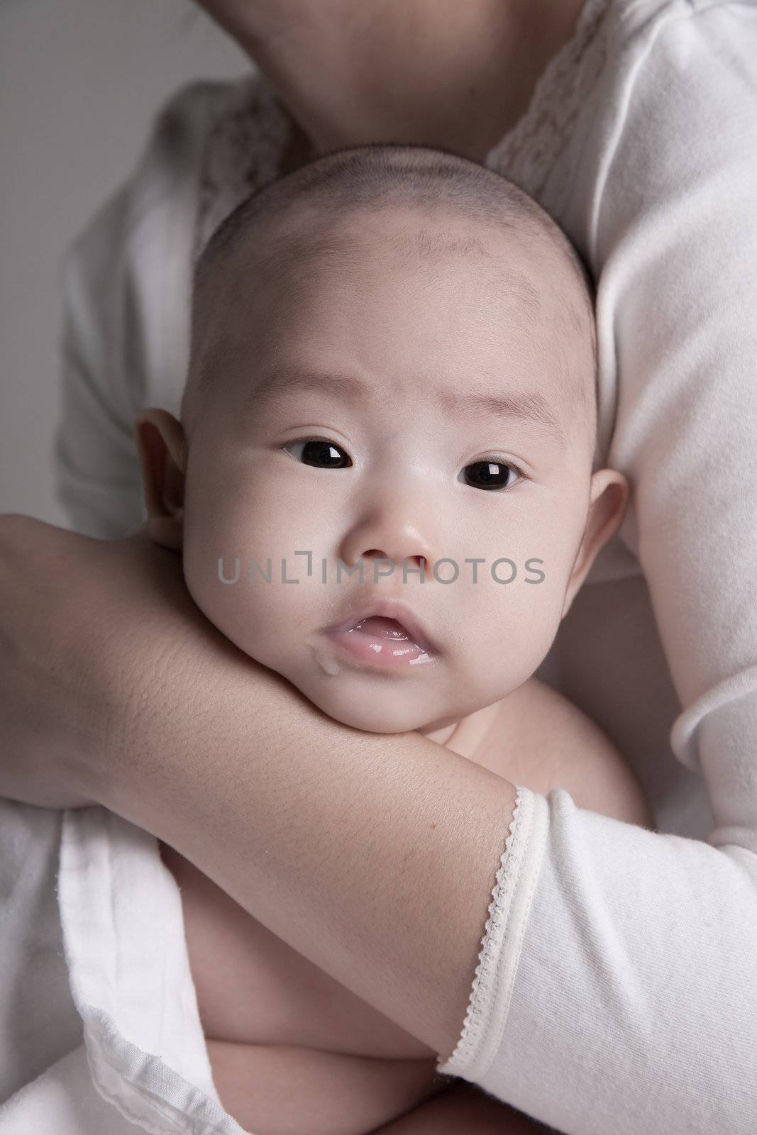 Studio shot of loving mother holding baby  by duron123