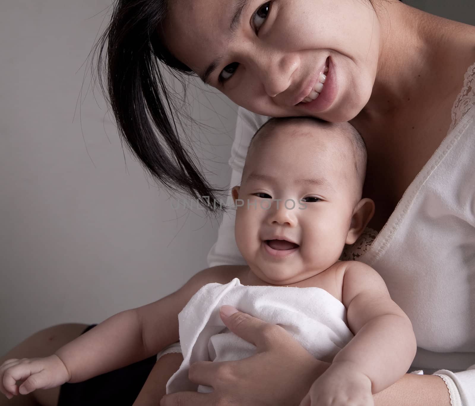 Studio shot of loving mother holding baby