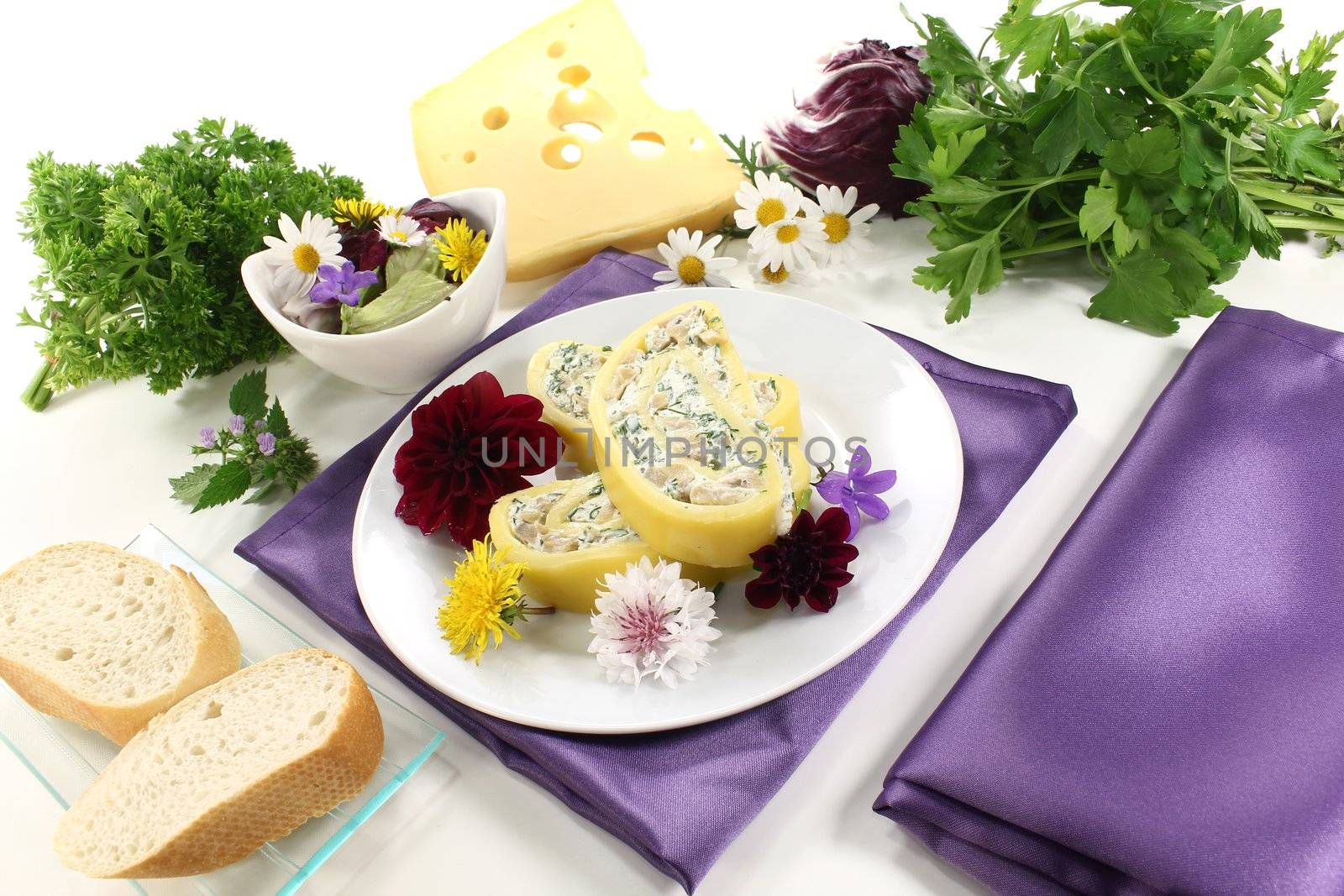 Cheese rolls with wild herb salad, bread and edible flowers