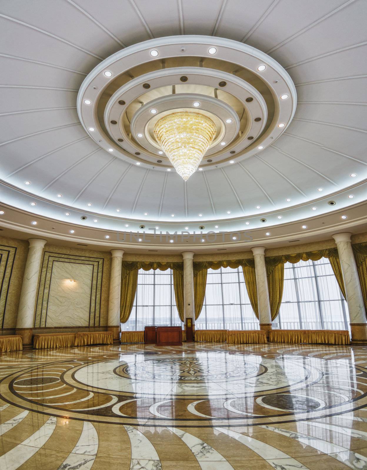 interior of the vast columned hall with a chandelier