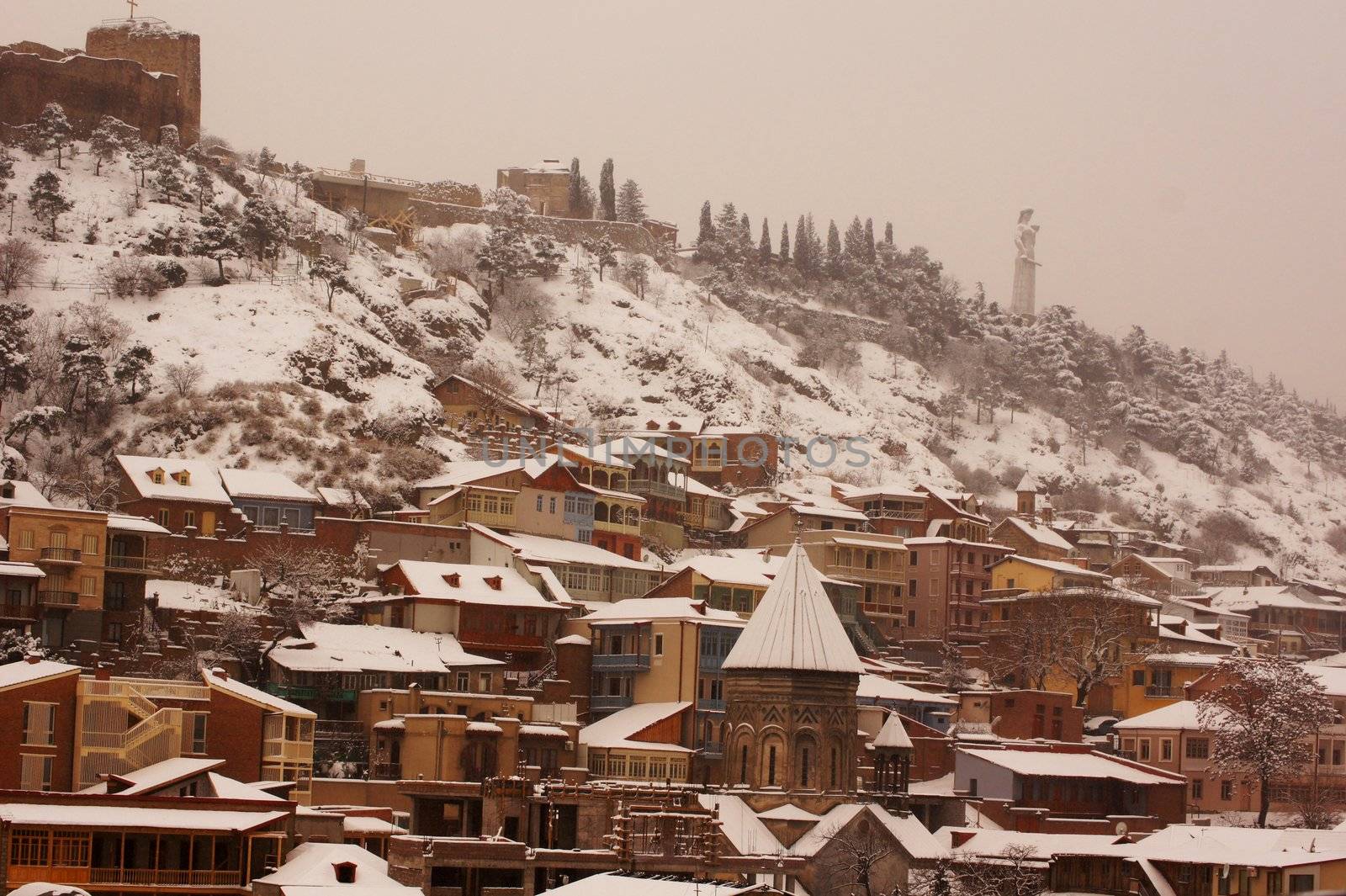 Winter view to covered with snow Tbilisi Old town in misty day