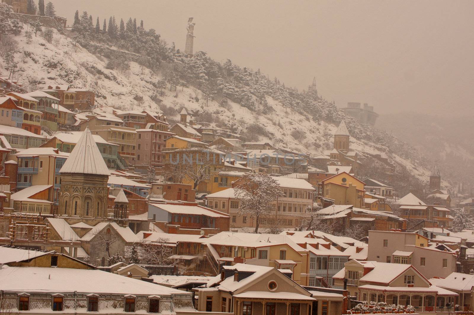 Winter view to covered with snow Tbilisi Old town in misty day