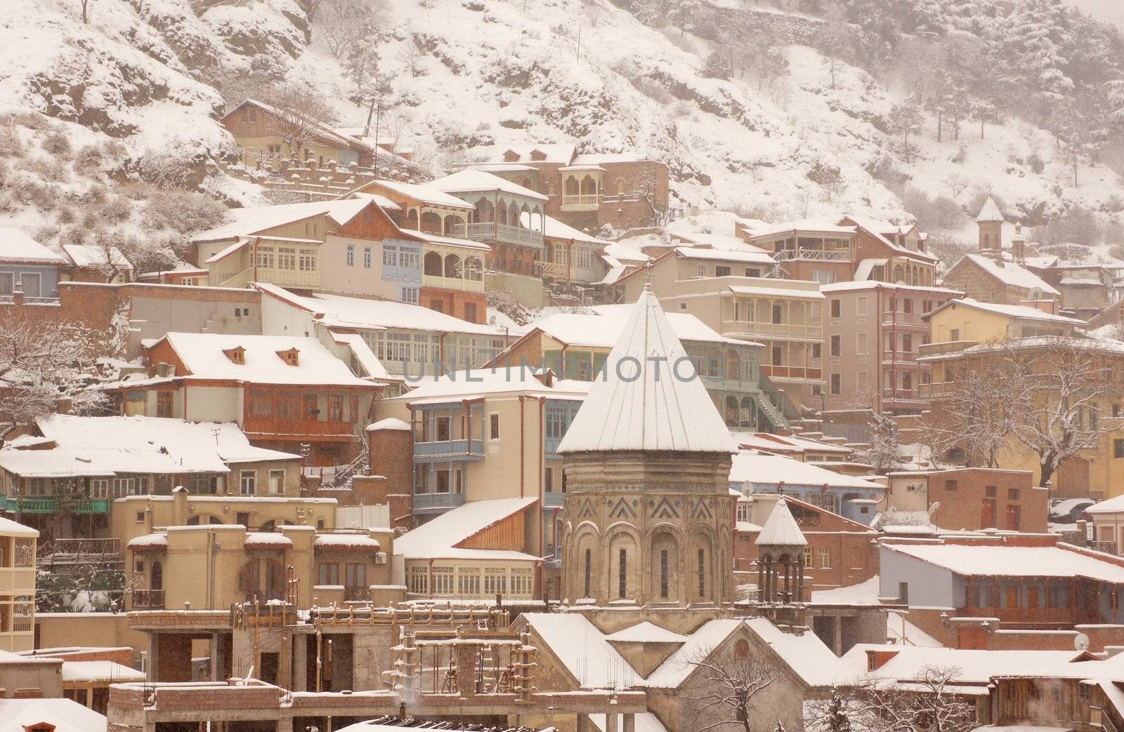 Winter view to covered with snow Tbilisi Old town in misty day by Elet