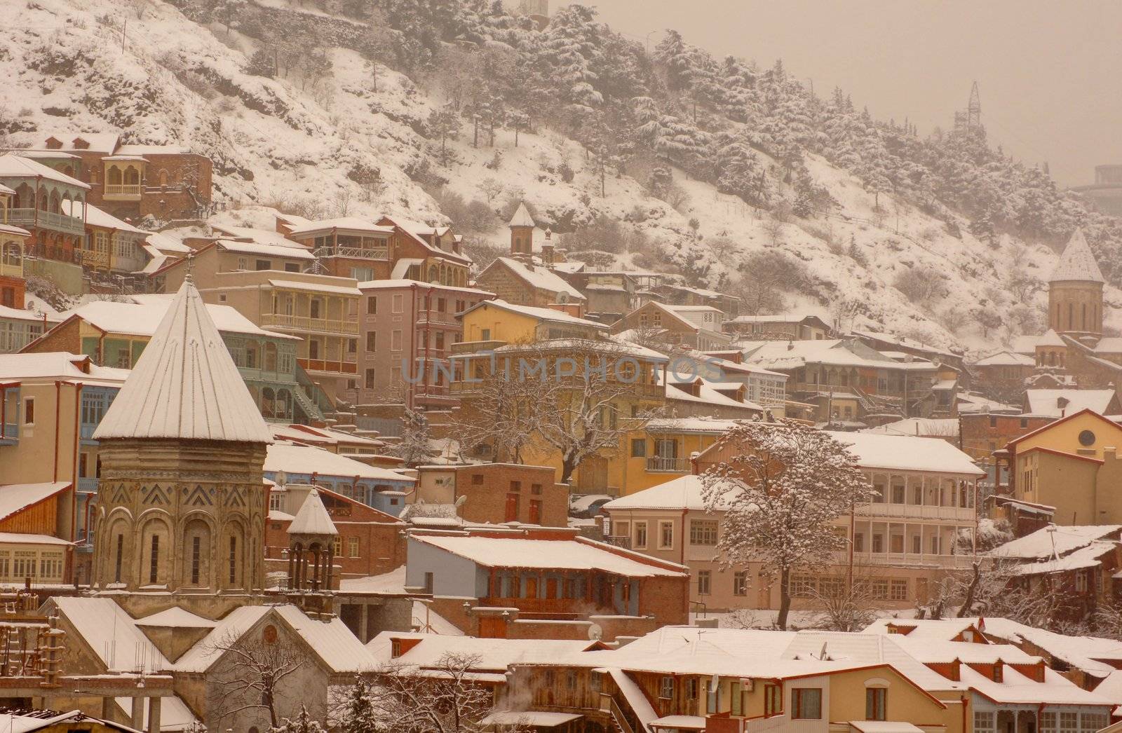 Winter view to covered with snow Tbilisi Old town in misty day by Elet