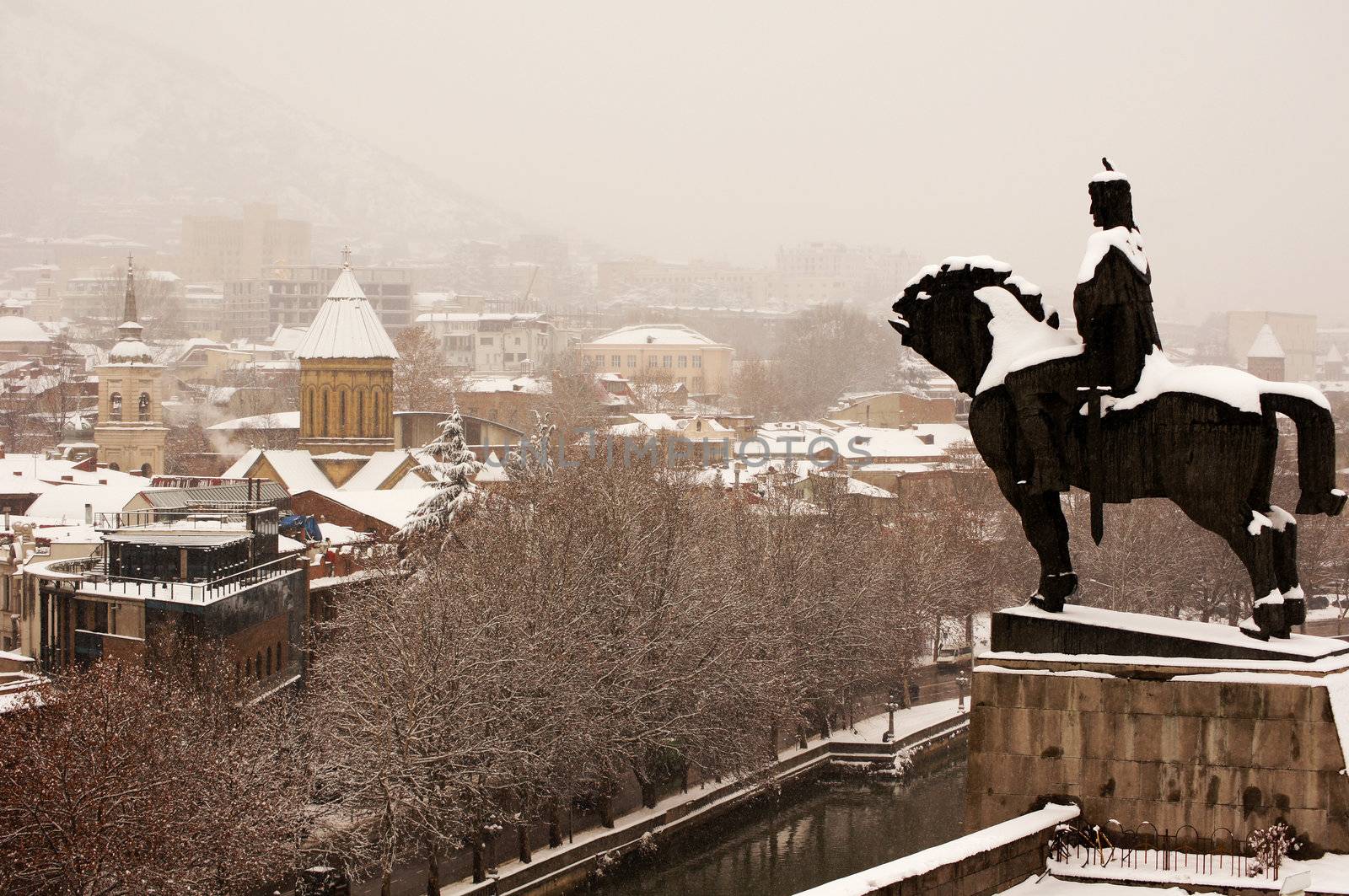 Winter view to covered with snow Tbilisi Old town in misty day by Elet