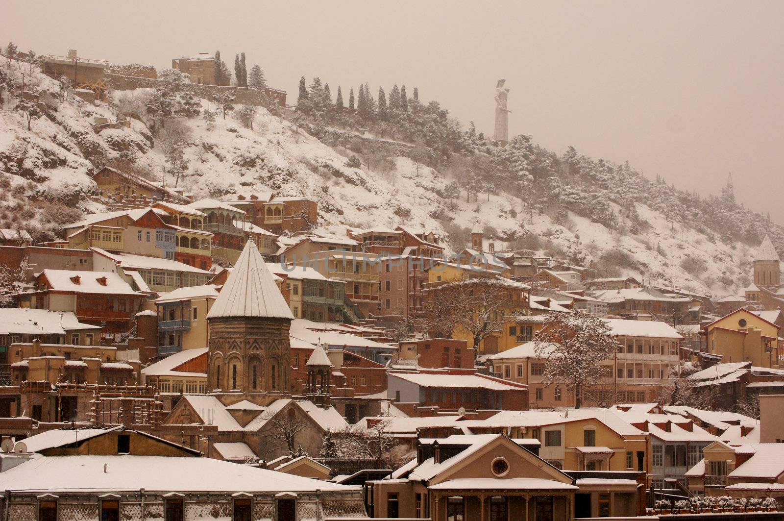 Winter view to covered with snow Tbilisi Old town in misty day by Elet