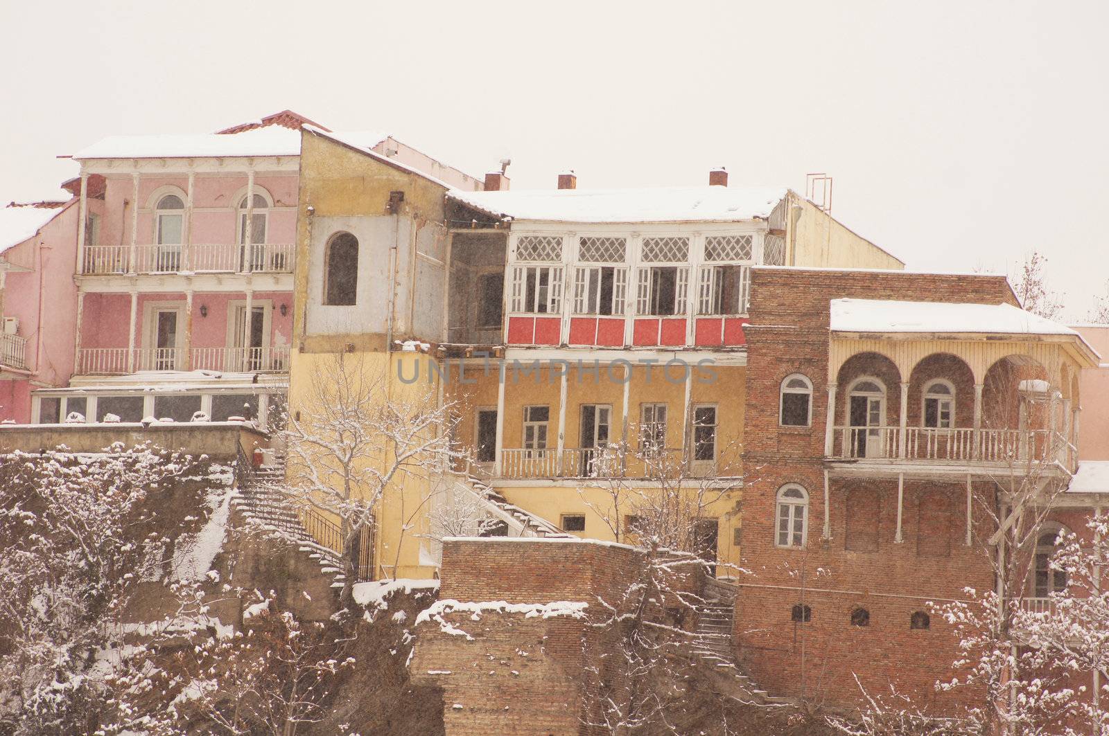 Winter view to covered with snow Tbilisi Old town in misty day by Elet