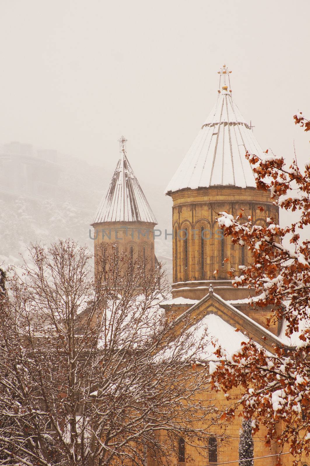 Winter view to covered with snow Tbilisi Old town in misty day by Elet