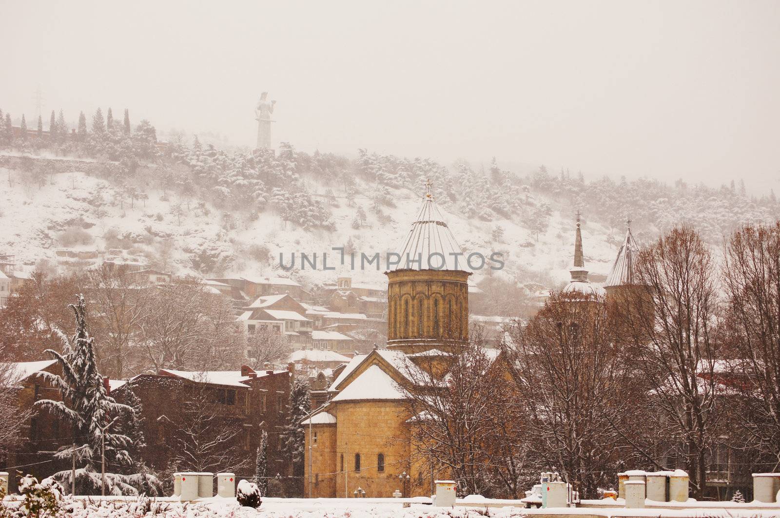 Winter view to covered with snow Tbilisi Old town in misty day