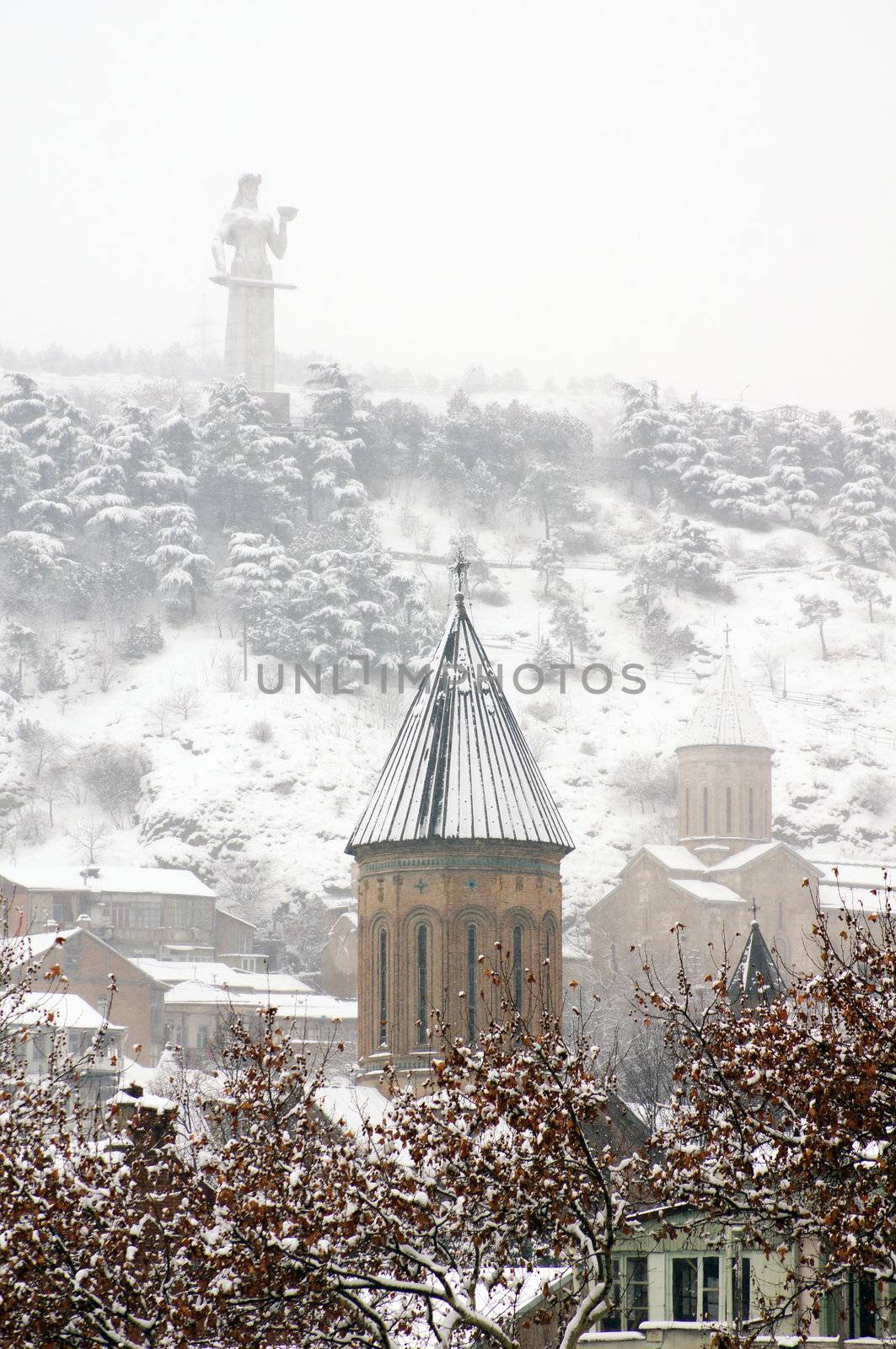 Winter view to covered with snow Tbilisi Old town in misty day by Elet