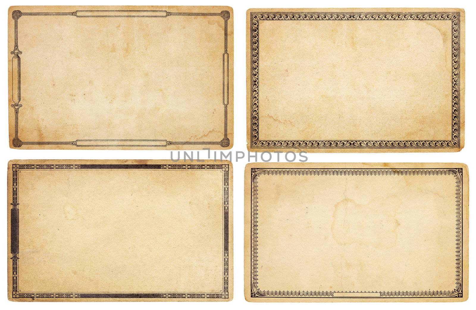 A set of four heavily aged, blank cards with stains, creases and tears.  Each card has different, old-fashioned decorative border. Isolated on white. Includes clipping paths.