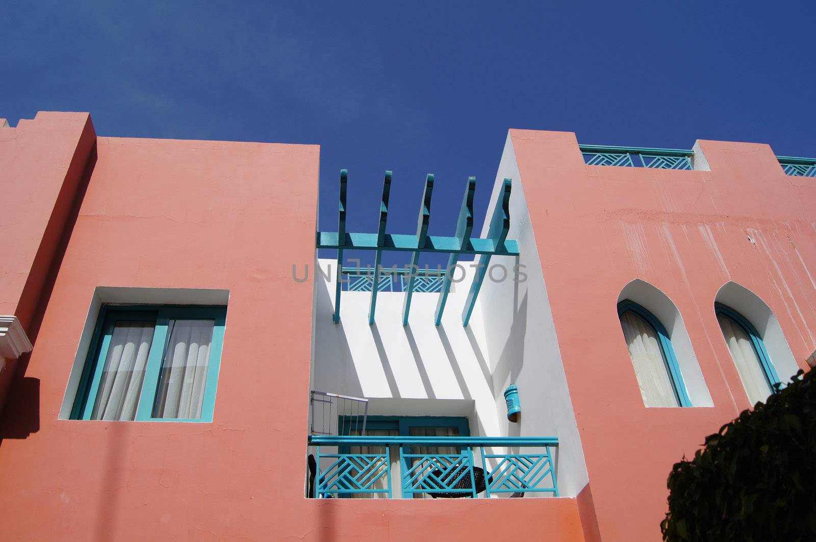 Arabic architecture: red walls villa with balcony   