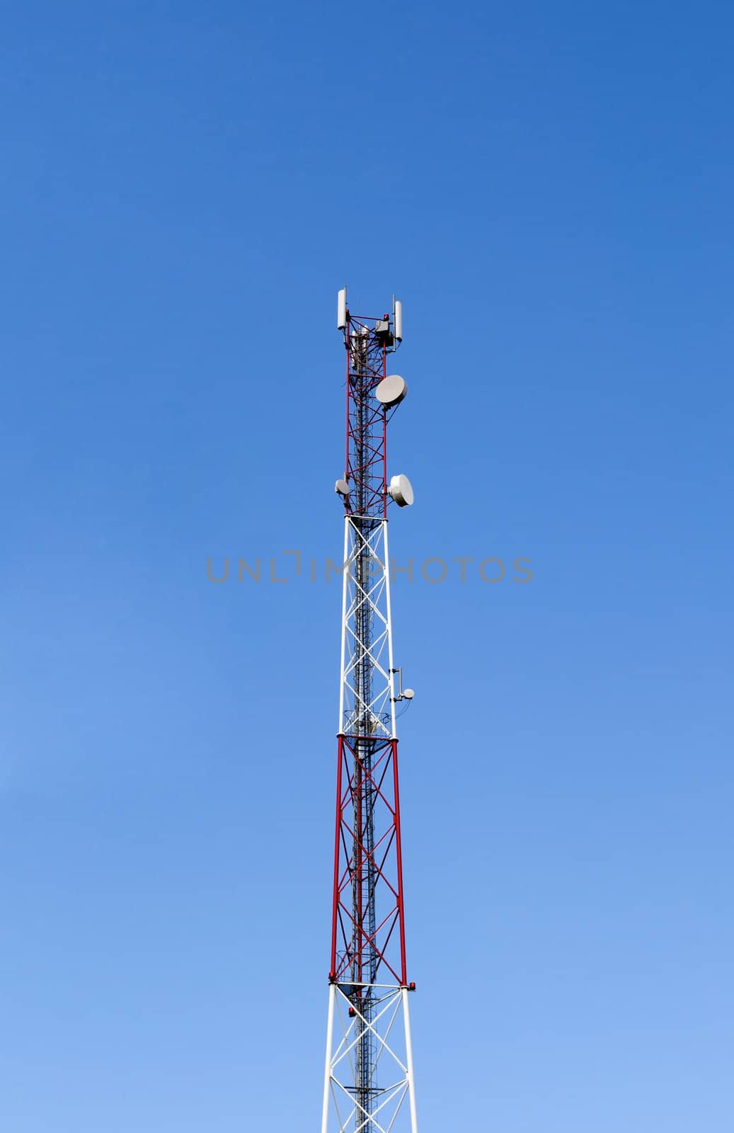 Top of a cellular tower on blue sky background