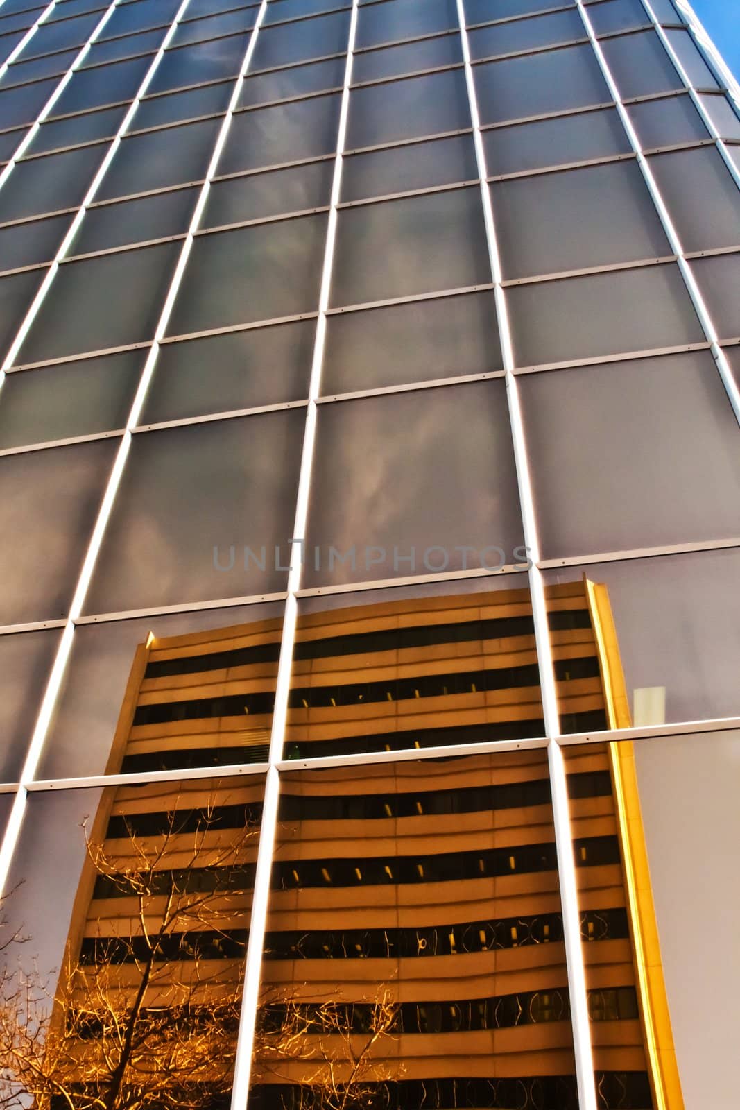 a city building with mirror-like reflections of the neighbouring building