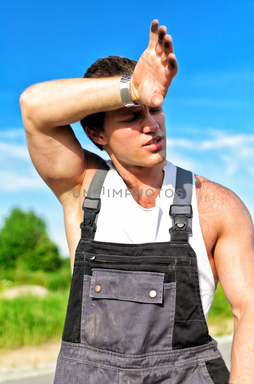 Portrait of a tired mechanic on a road