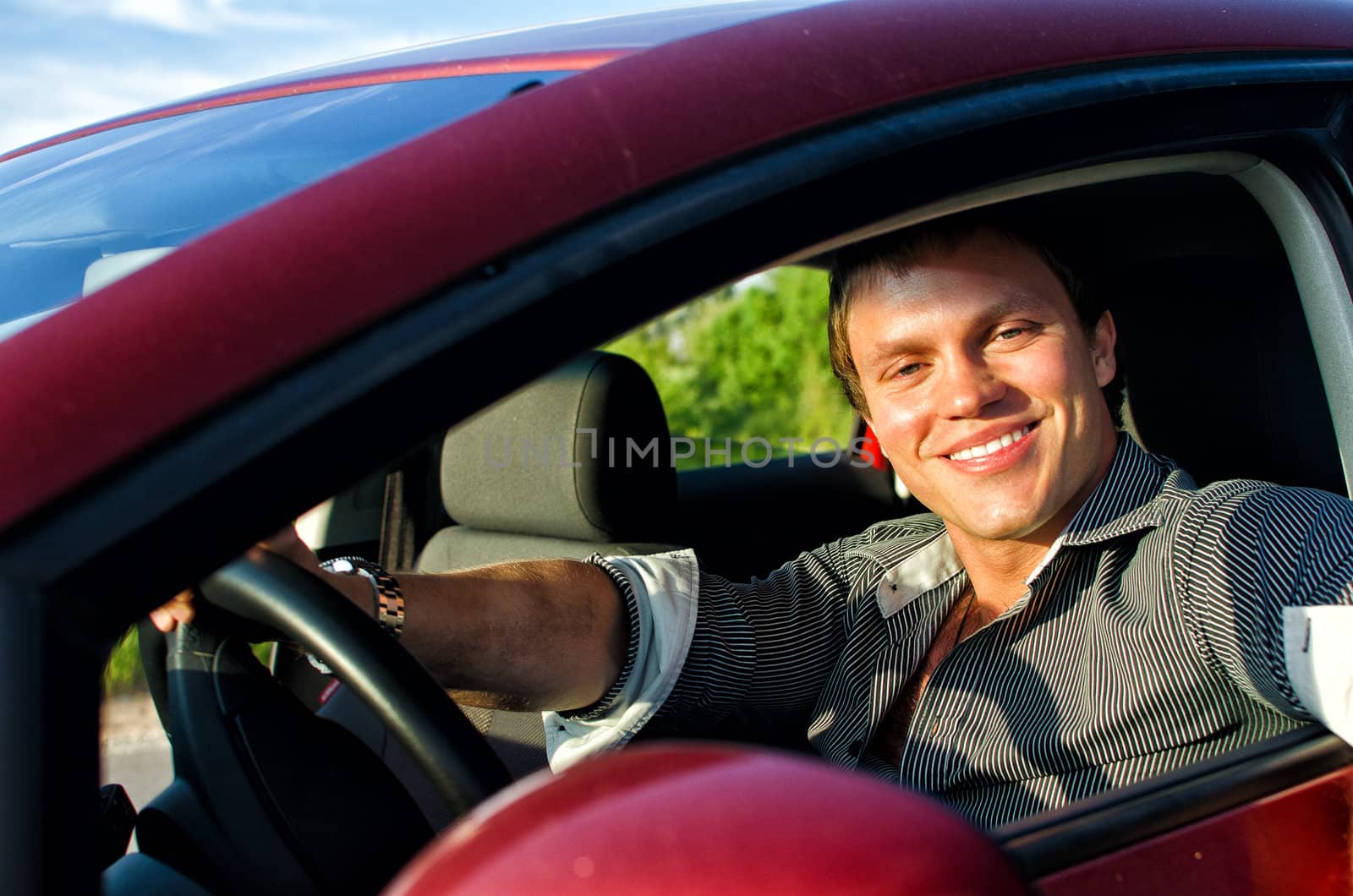 Portrait of a handsome man inside the car