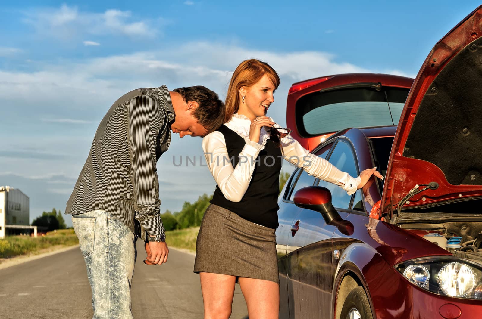 Tired man leaning to his gilfriend shoulder near broken car by dmitrimaruta