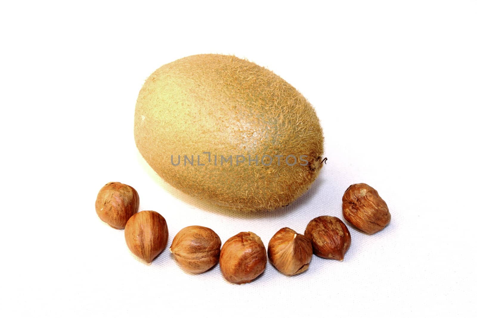 some hazelnuts are excelent to eat with a kiwi fruit