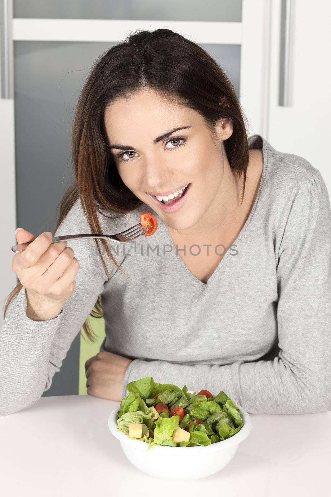 beautiful young girl eating healthy food at home