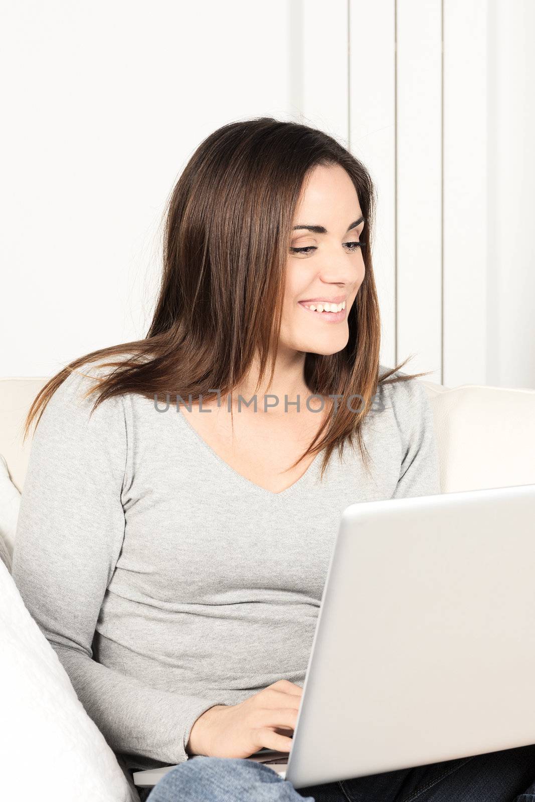 Portrait of young woman using laptop  by vwalakte