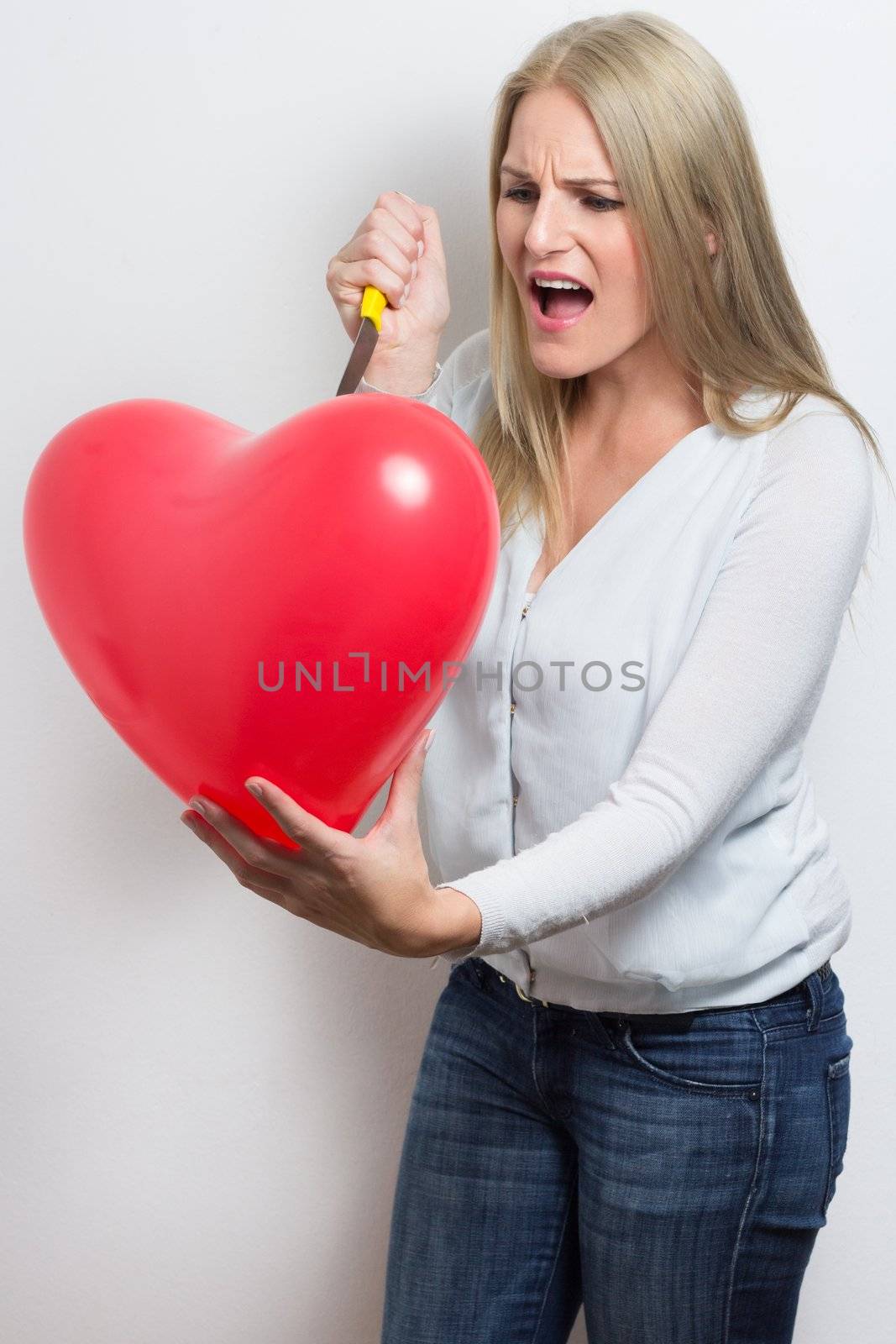 Woman destroying heart after breakup by dwaschnig_photo
