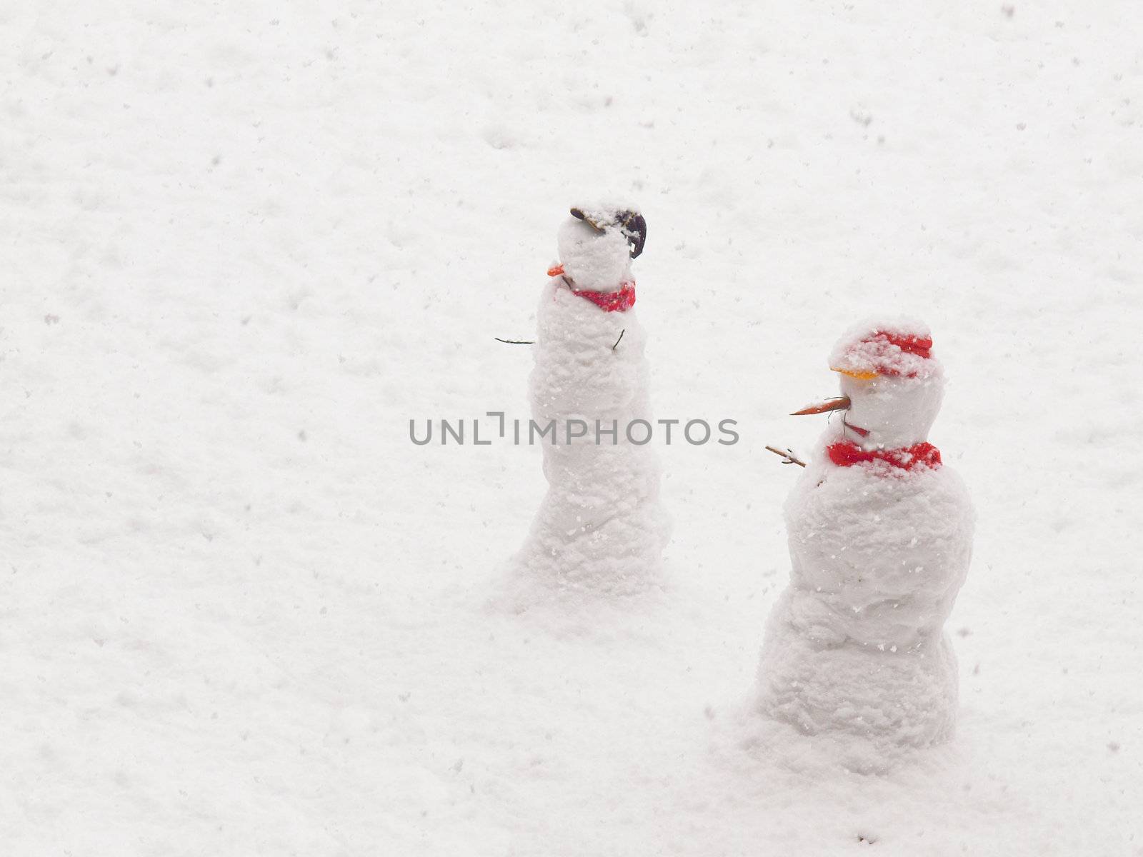 Snowman anthropomorphic snow sculptures over snow background