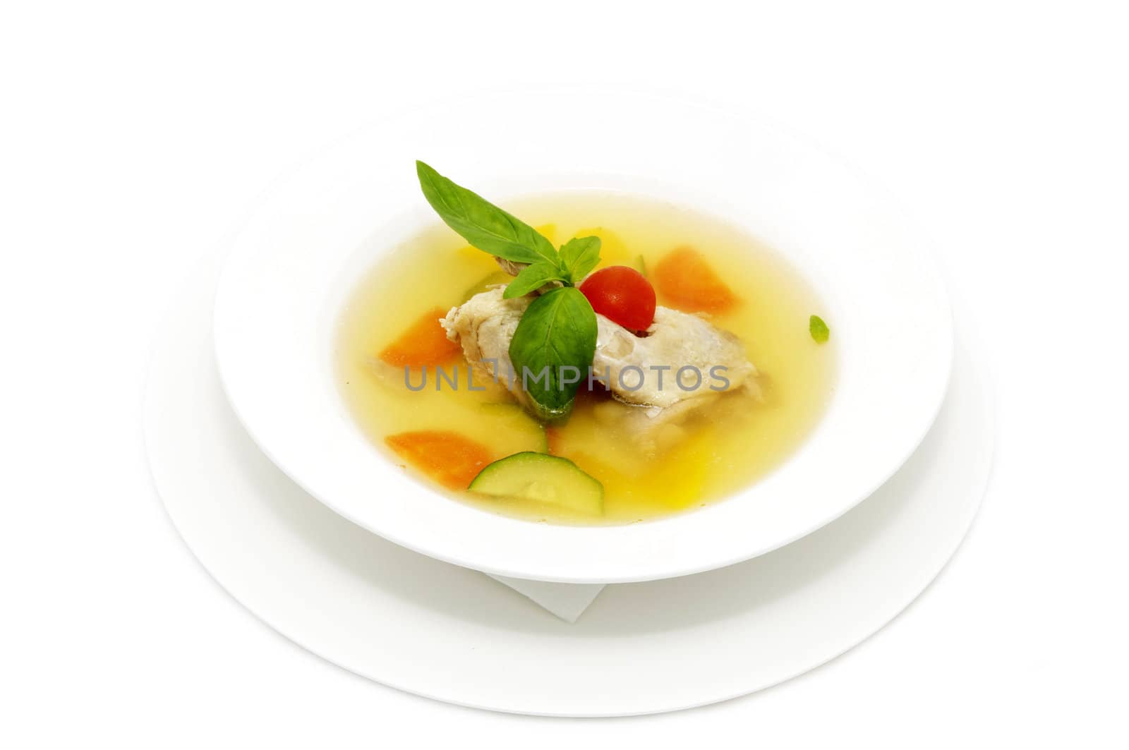 quail broth with vegetables decorated with mint
