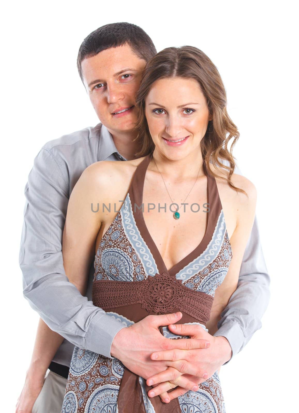 Closeup portrait of a sweet happy young couple smiling together. Isolated on white background