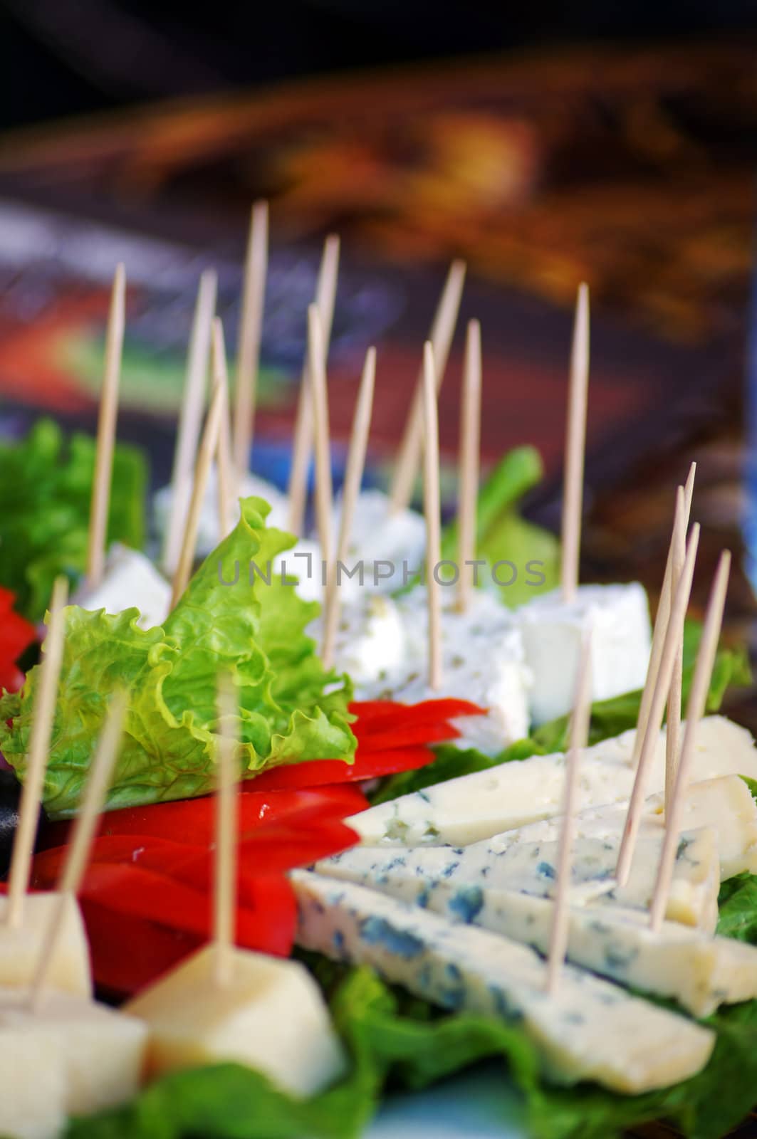 Different cheese sorts and vegetables on the plate