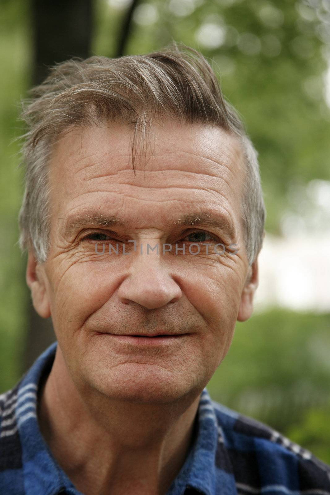 Portrait of the elderly tired man