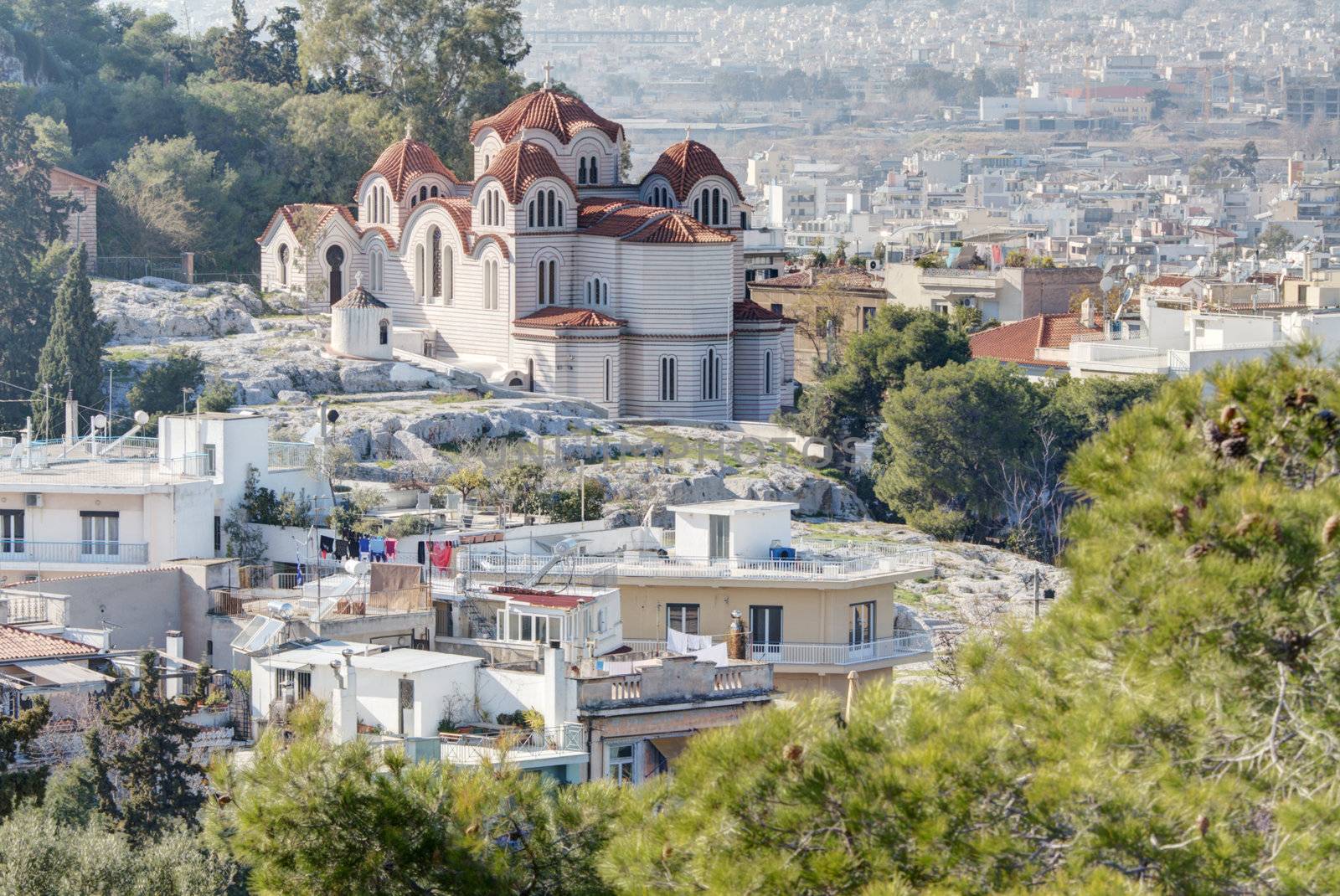 Agia Marina or Saint Marina orthodox church situated on the Hill of the Nymphs in Athens, Greece. The city of Athens can be seen in the background.