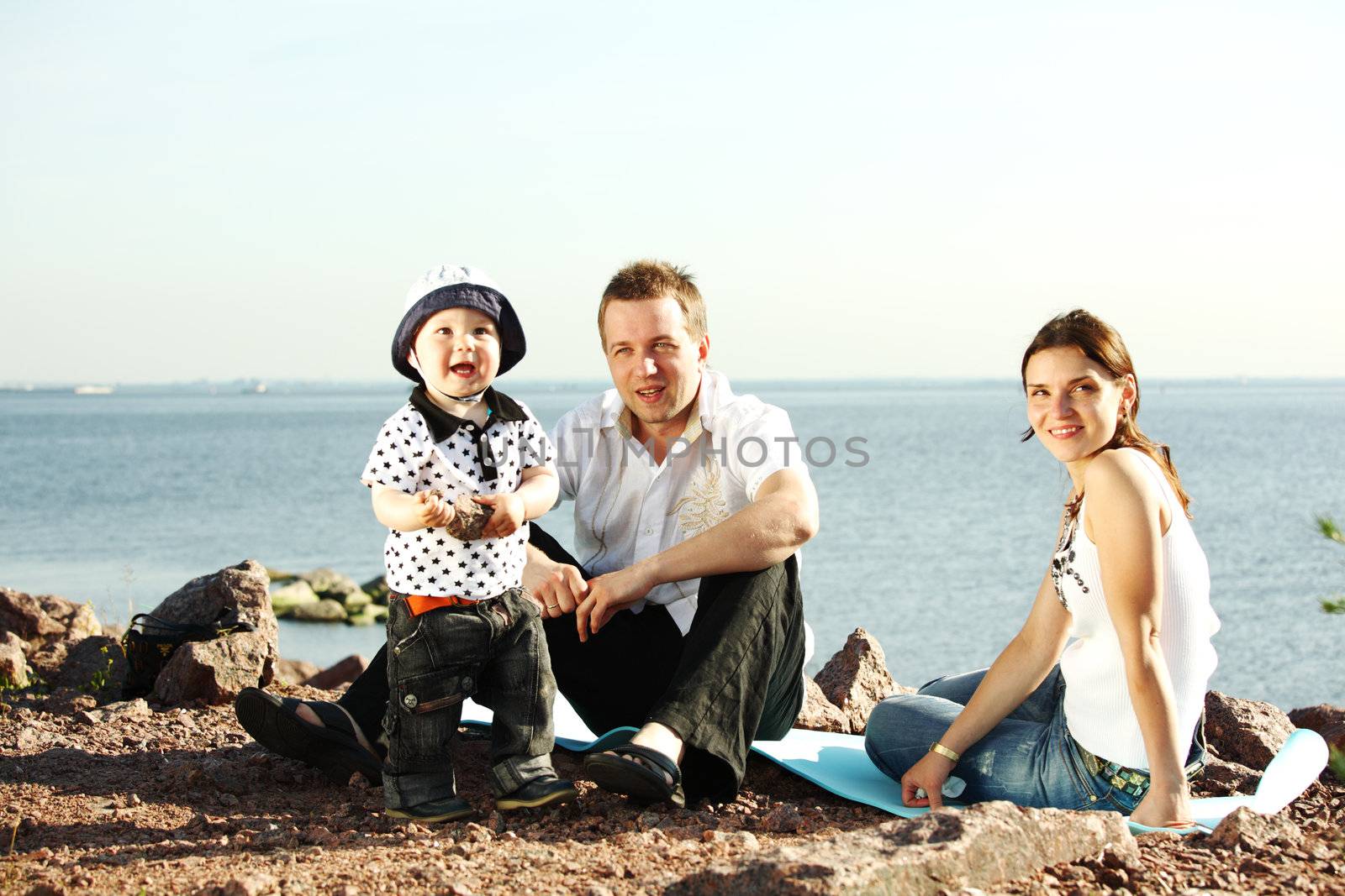 happy family on picnic sea on background