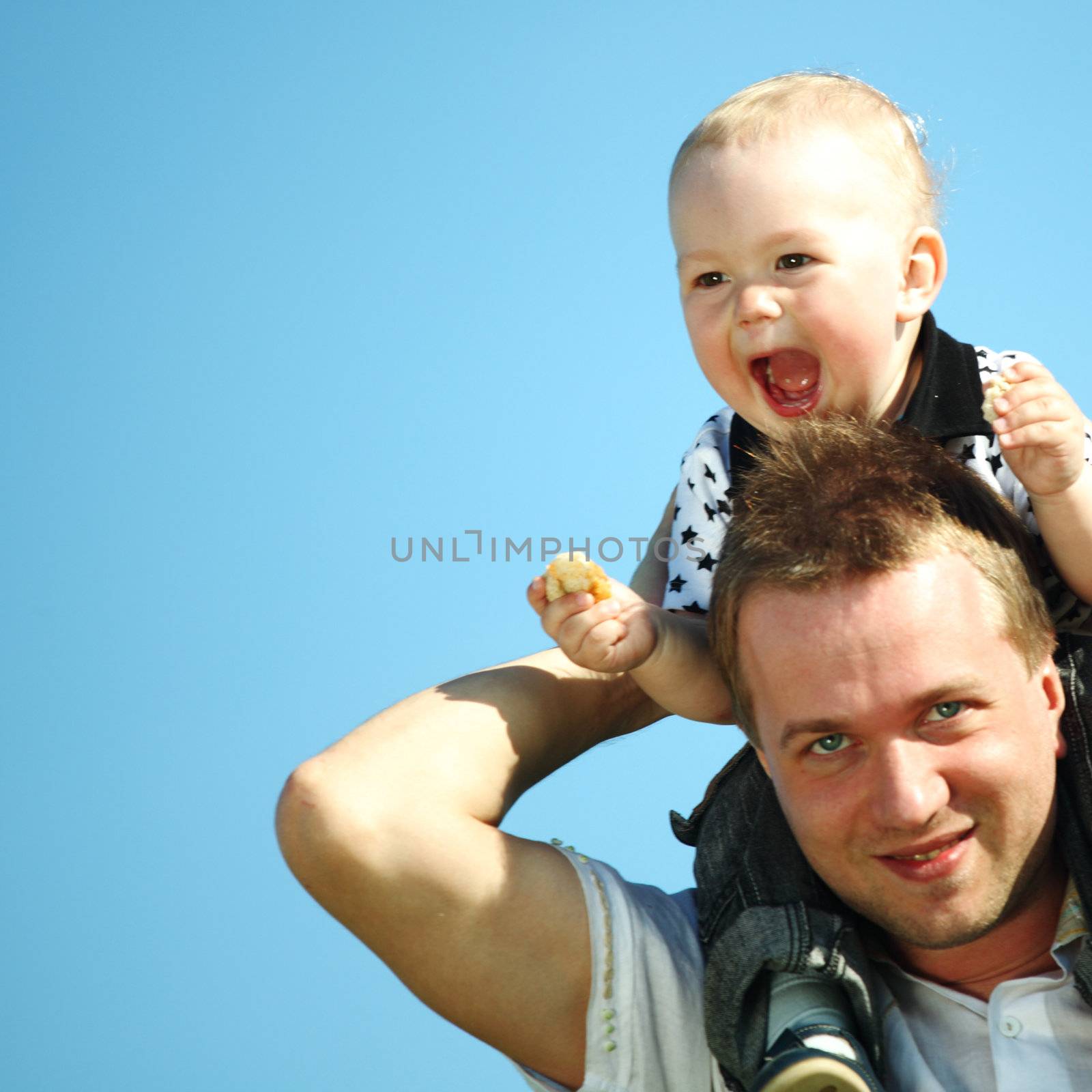 father and son in blue sky