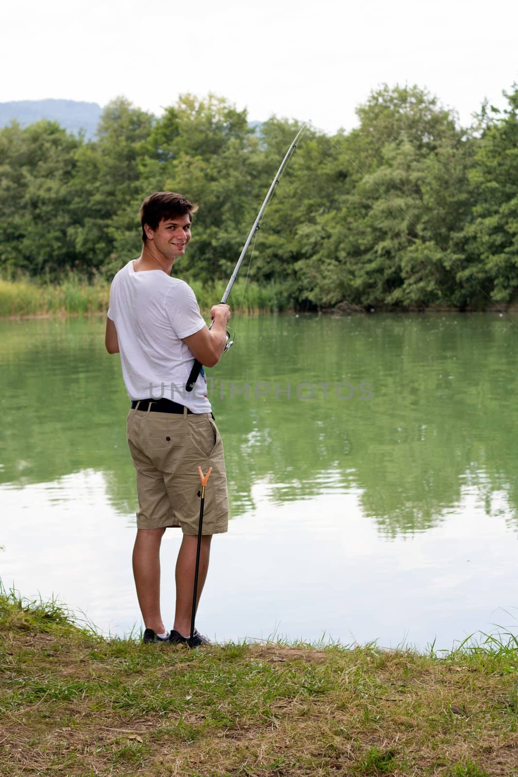 Man Fishing at a lake by dwaschnig_photo